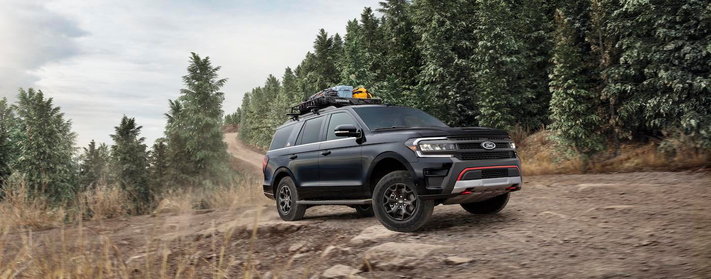 A black 2023 Ford Expedition Timberline is shown from the front at an angle after leaving a dealer that has a Ford Expedition for sale.