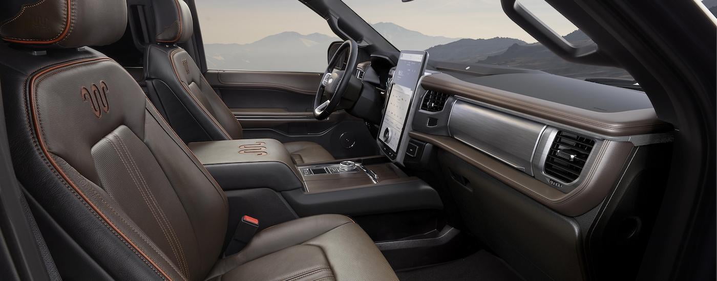 The brown interior of a 2023 Ford Expedition King Ranch is shown from the passenger side.
