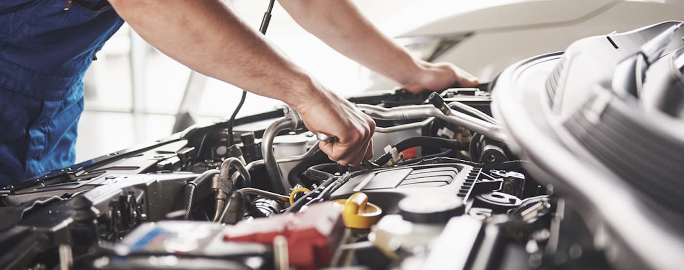A mechanic performing maintenance on an engine block.