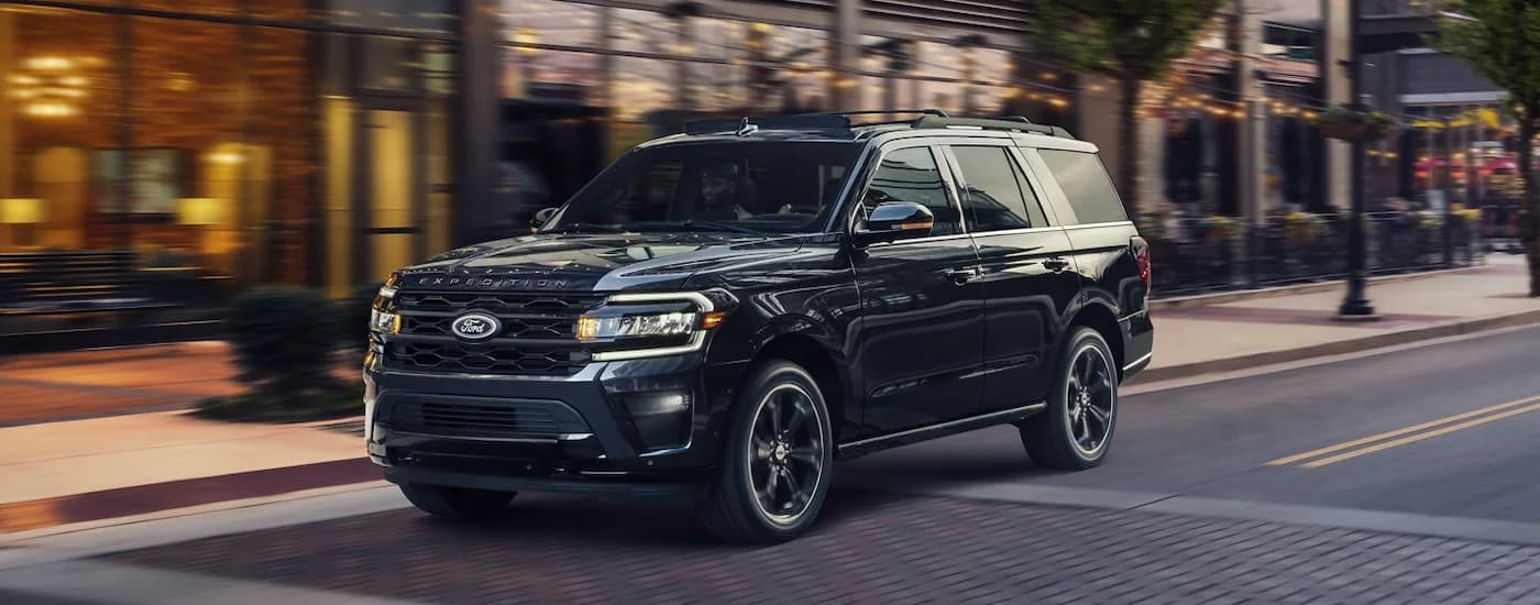 Ford Dealer in Brooklyn - 2023 Ford Expedition Stealth - black.jpg A black 2023 Ford Expedition Stealth driving on a city street after leaving a Ford dealer in Brooklyn.