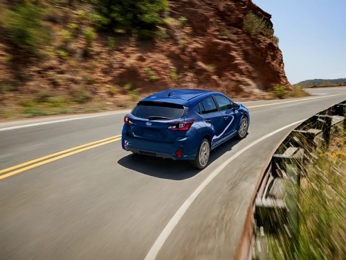 2026 Subaru Impreza driving around a curve