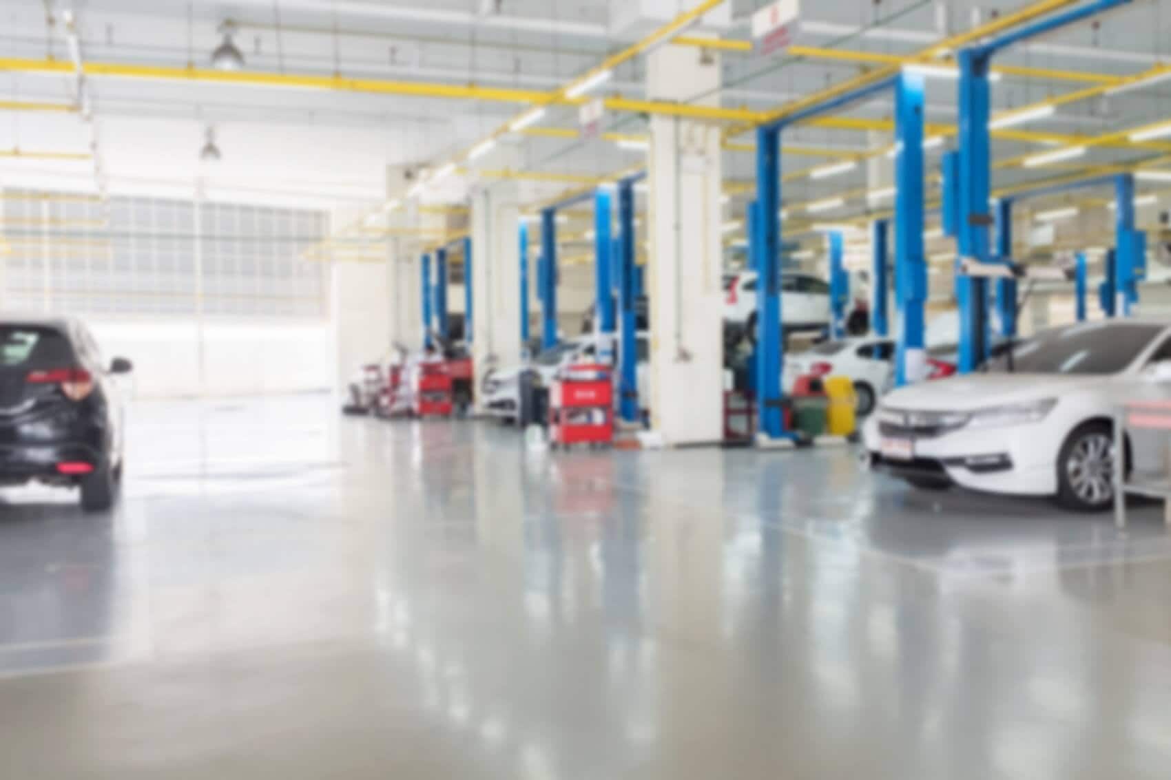 A shot of our service center and service bays with vehicles parked in them. Schedule Service at Audi North Miami in North Miami FL online today. 