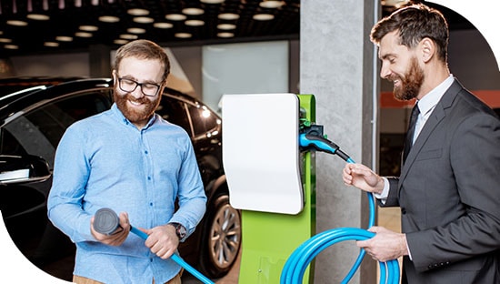 Two people discussing an electric vehicle charger
