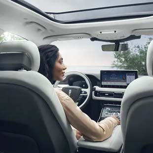 interior view of woman driving a Lincoln