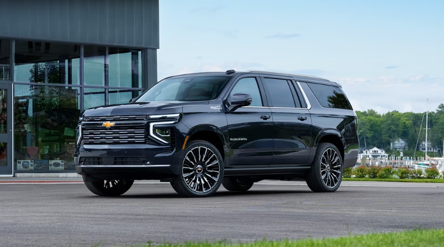 A 2026 Chevrolet Suburban parked in a snowy Massillon driveway, highlighting its all-weather capability and family safety features.