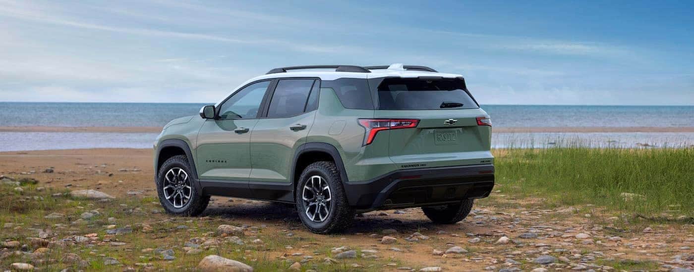 Rear of a green 2026 Chevy Equinox ACTIV parked off-road