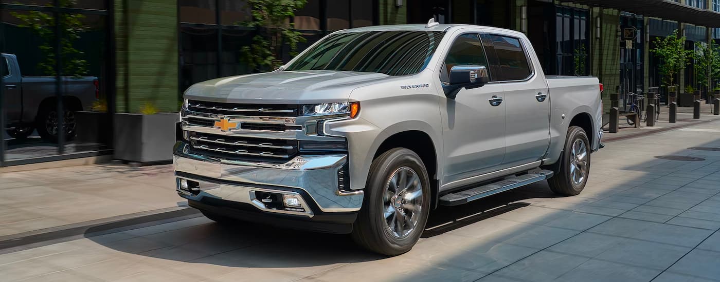 Silver 2019 Chevy Silverado 1500 driving through a city