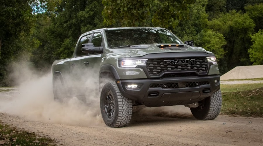 Front profile of a 2026 Ram 1500 driving down a Massillon road near Sippo Lake during a crisp autumn morning