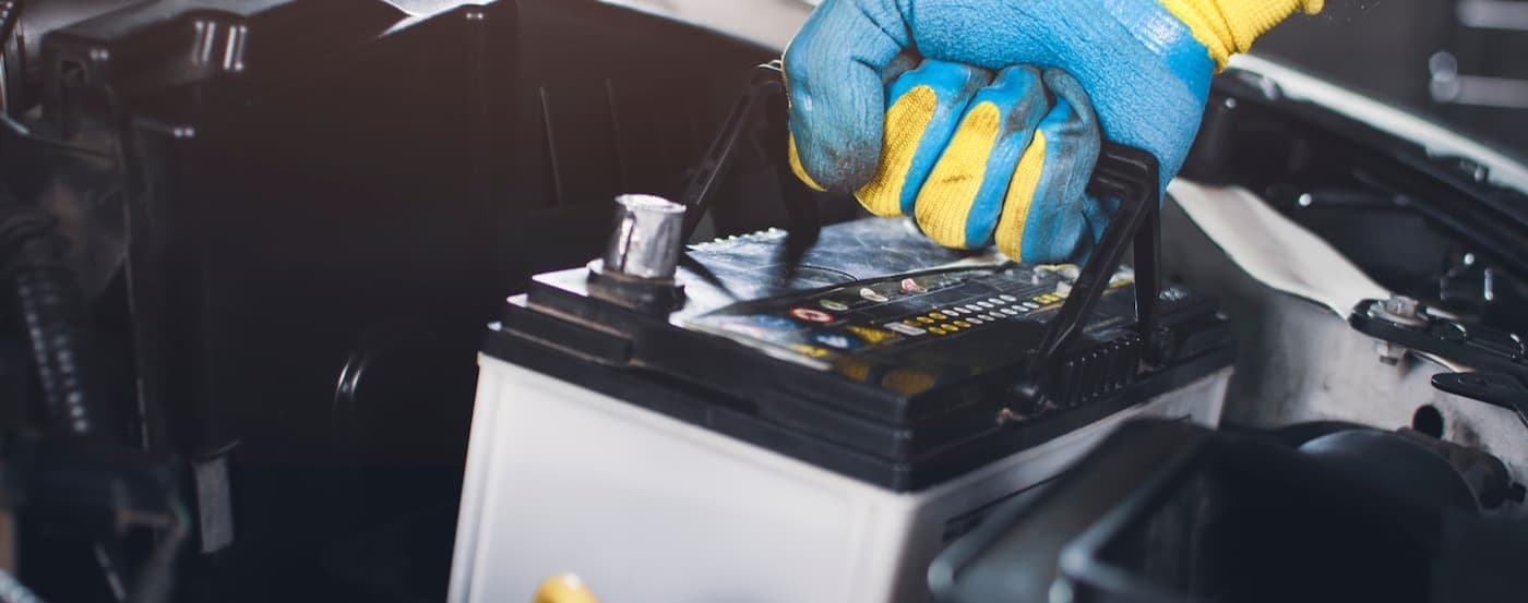 A technician installing a battery.