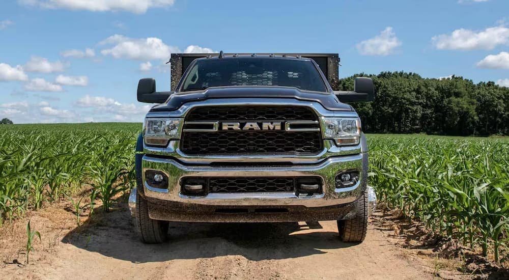 A black 2024 Ram 5500 is parked in a field.