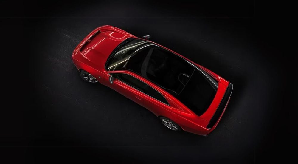 A red 2025 Dodge Charger Daytona Scat Pack is shown from a high angle.