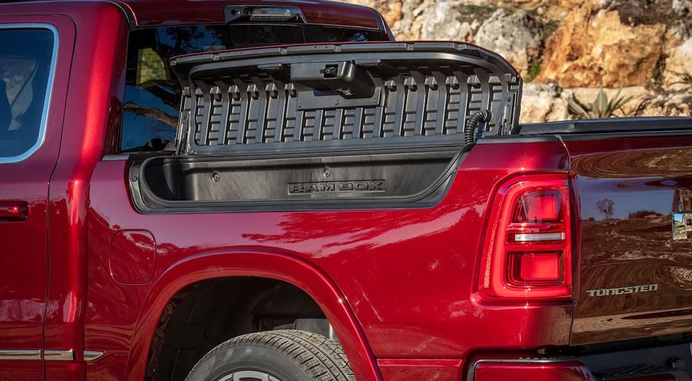 A close up shows the RamBox on a red 2025 Ram 1500 Tungsten.