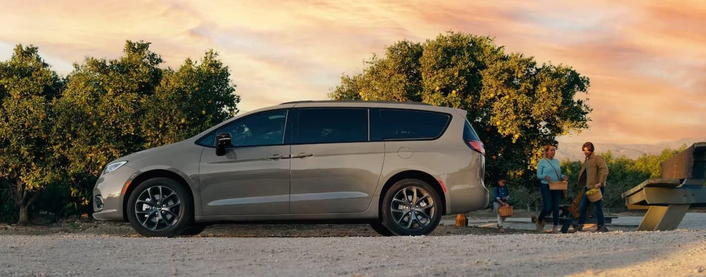 A tan 2024 Chrysler Pacifica is shown from the side.
