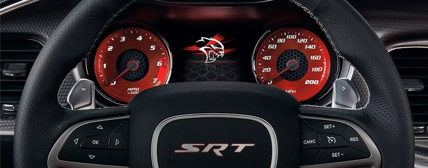A close up of the steering wheel and gauge cluster in a 2023 Dodge Charger SRT.