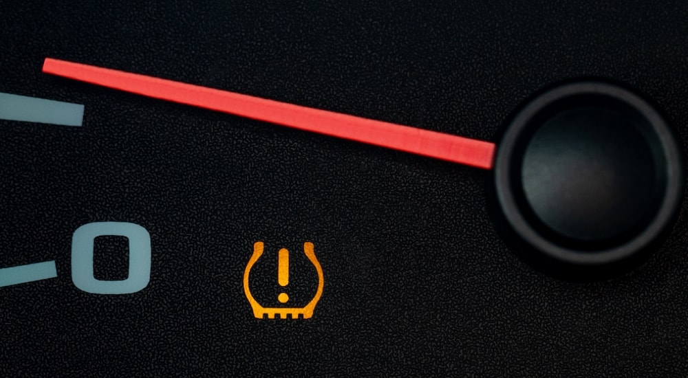 Close-up of the tire pressure light on the dashboard of a vehicle.