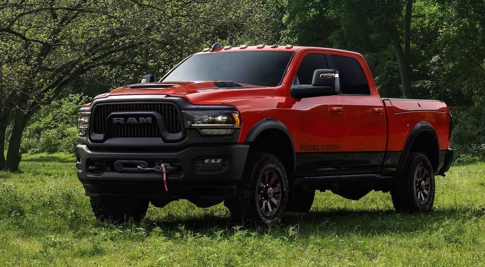 A red 2024 Ram 2500 Power Wagon is shown from the front at an angle while off-road.