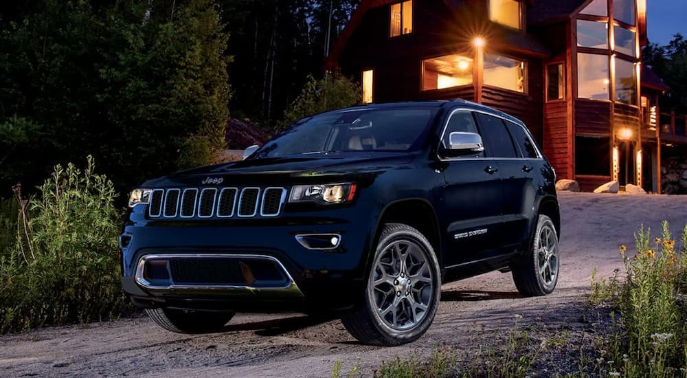 A black 2022 Jeep Grand Cherokee WK is parked in a driveway.
