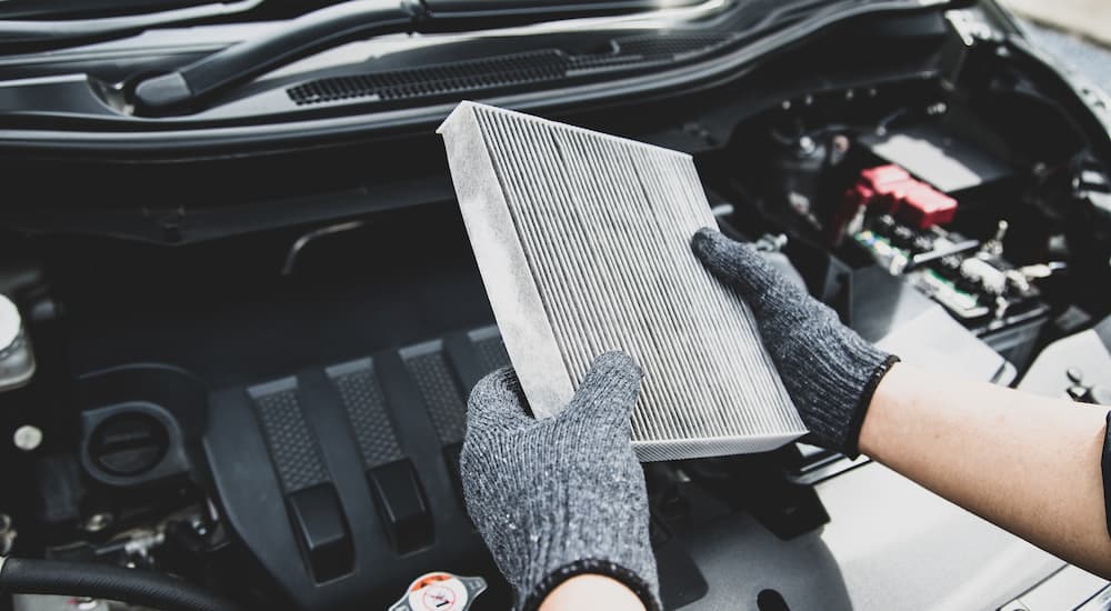 A mechanic is changing the air filter on a truck.