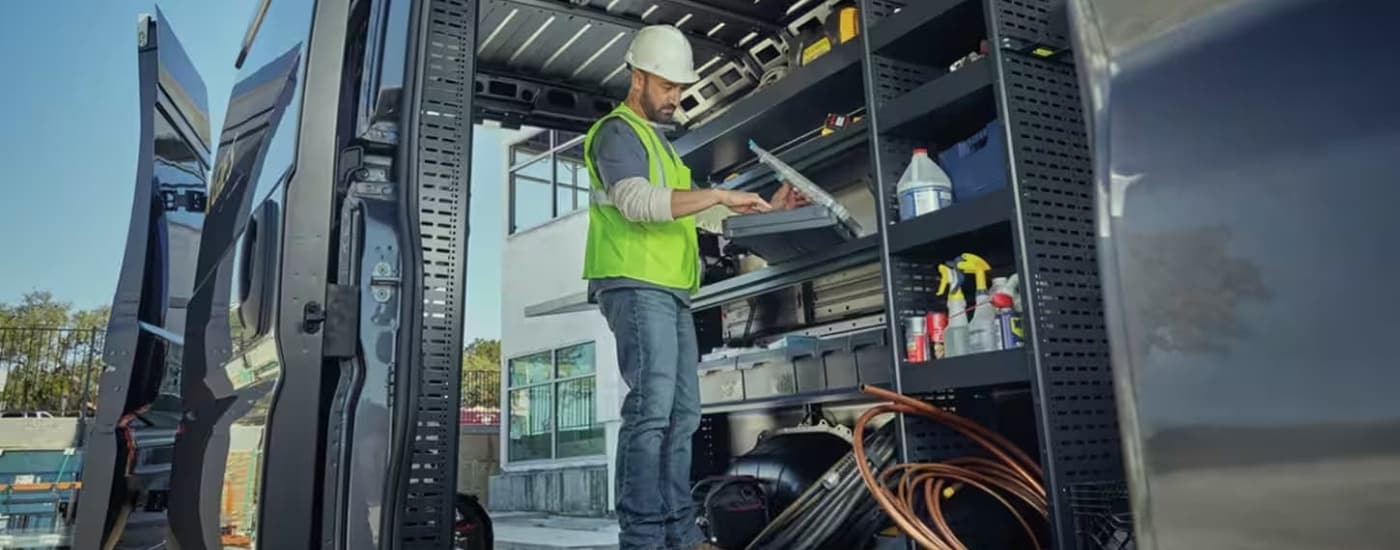 A worker is shown in the back of a 2024 Ram Promaster.