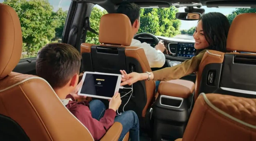 The brown and black interior is shown in a 2024 Chrysler Pacifica.