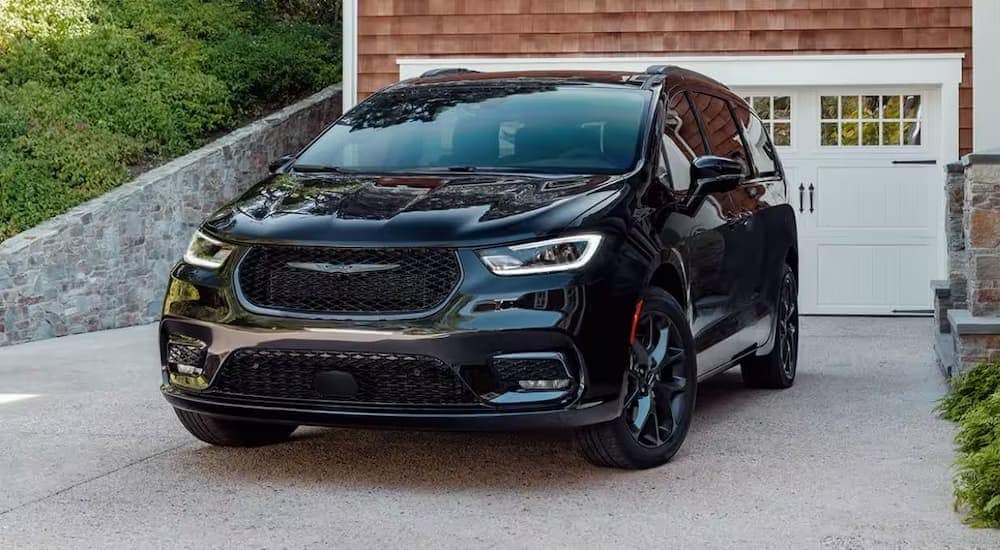 A black 2024 Chrysler Pacifica is shown parked after visiting a Chrysler dealer.