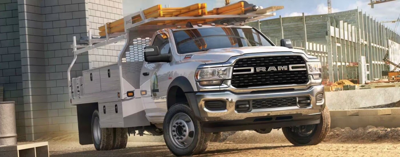 A white 2024 Ram 4500 Chassis Cab with utility upfit on a construction site.