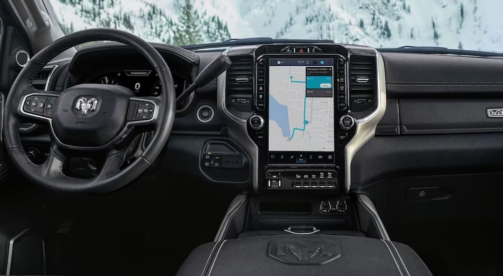 The black dash and infotainment screen are shown in a 2024 Ram 2500.