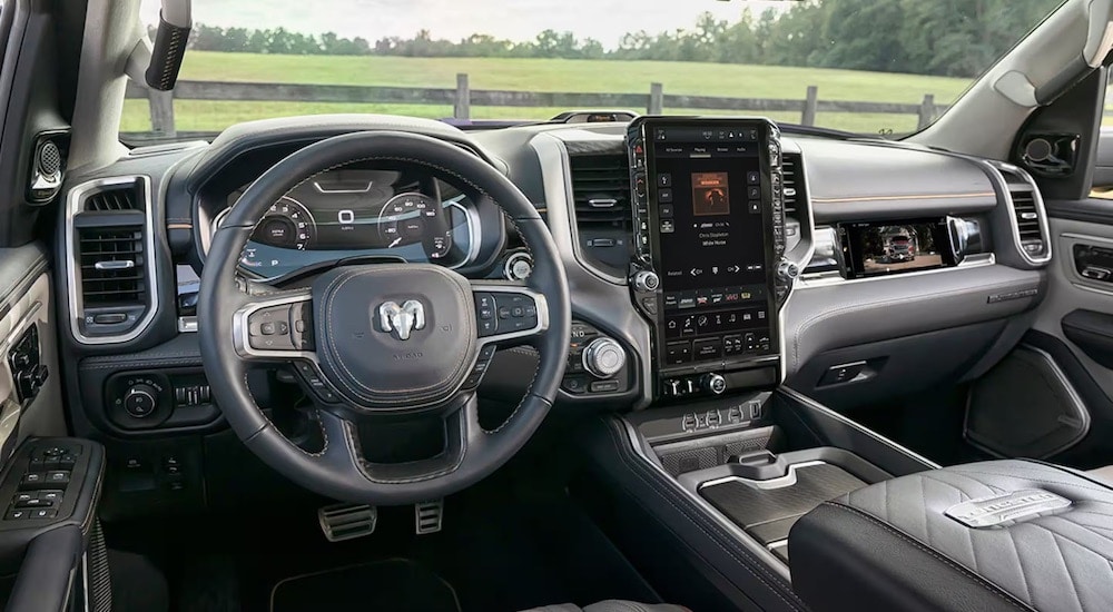 A close up shows the grey dash and infotainment screen in a 2025 Ram 1500 Tungsten.