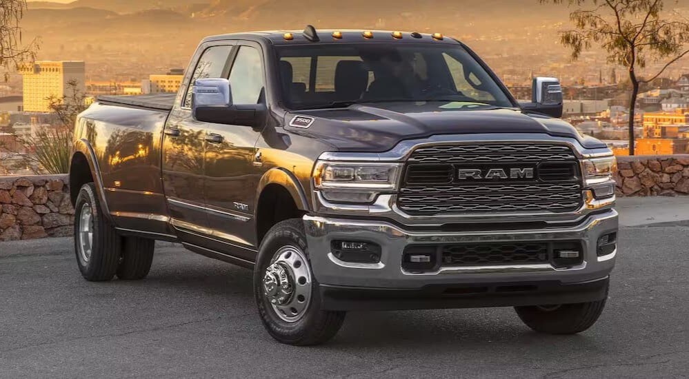 A grey 2024 Ram 3500 is shown overlooking a city.