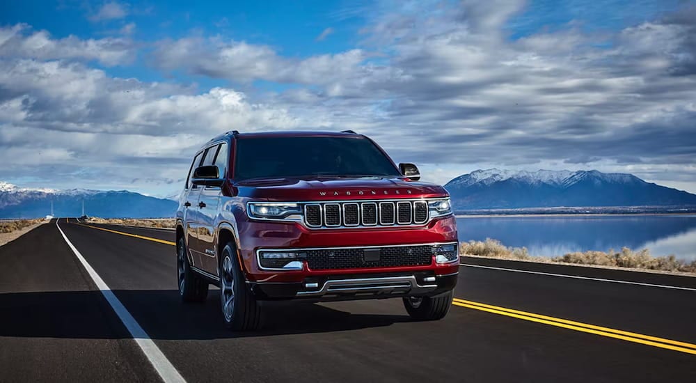 A red 2024 Jeep Wagoneer driving from a Jeep dealer near Lancaster.