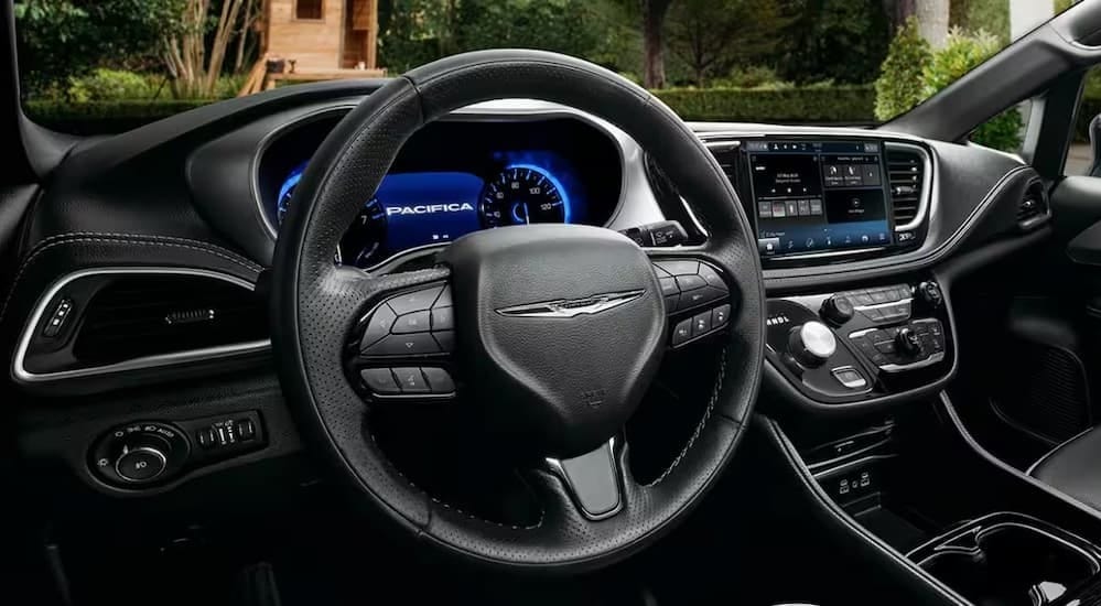 The black interior and dash in a 2024 Chrysler Pacifica is shown.