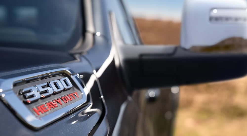 A close-up on the badge of a black 2024 Ram 3500.