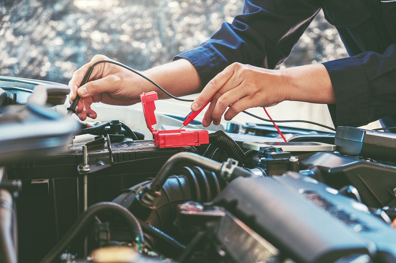 GMC battery service technician testing a battery