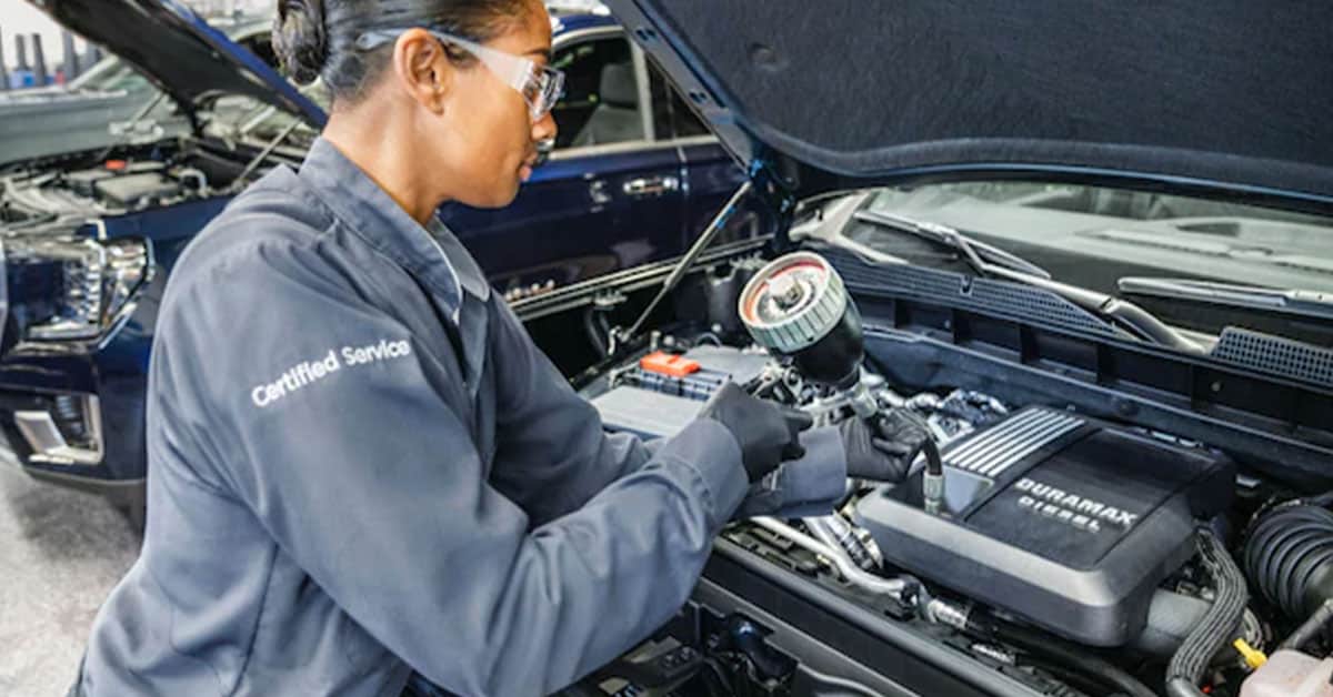 GMC service technician working on an oil change