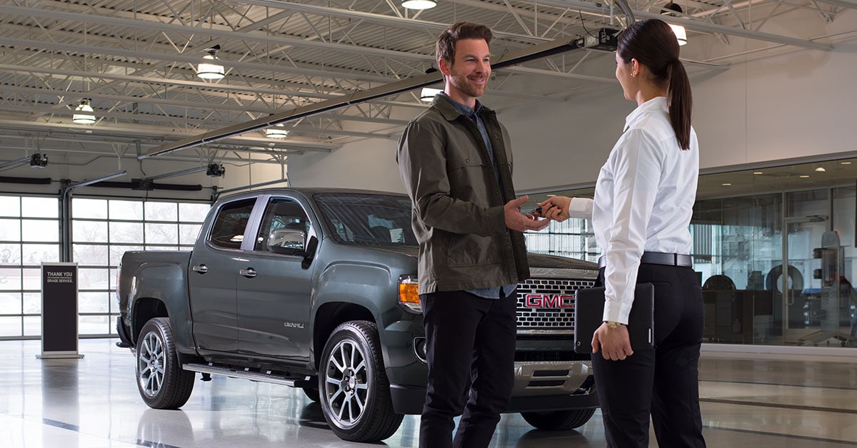 Customer speaking with salesperson at GMC dealership in Provo, UT
