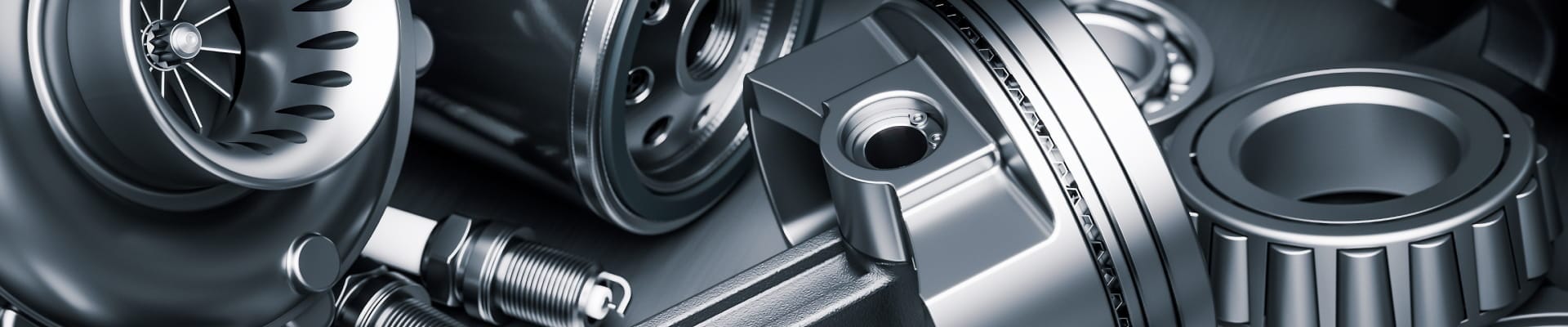 Close-up of automotive engine components, including a turbocharger, spark plugs, brake disc, and bearing.