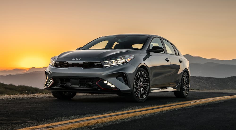 A popular Kia Forte for sale, a grey 2023 Kia Forte GT, is shown at sunset.
