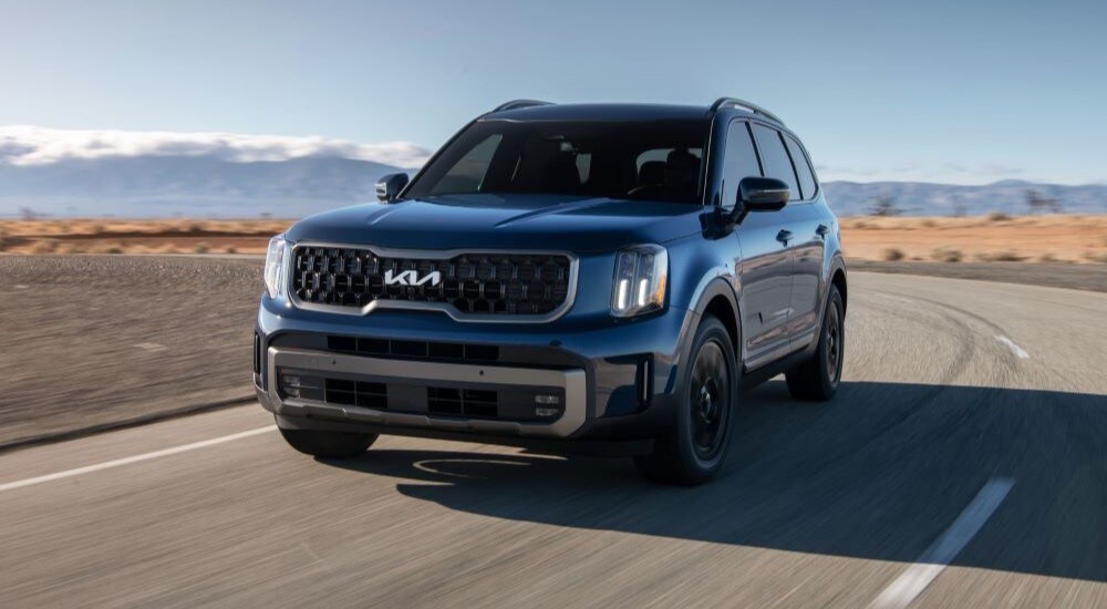 Philadelphia Kia Telluride Dealer - 2023 Kia Telluride - Corner.jpg A blue 2023 Kia Telluride is shown rounding a corner after leaving a Philadelphia Kia Telluride dealer.