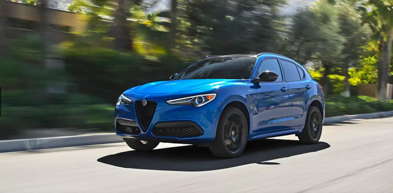 2023 Alfa Romeo Stelvio SUV blue exterior color driving on the road