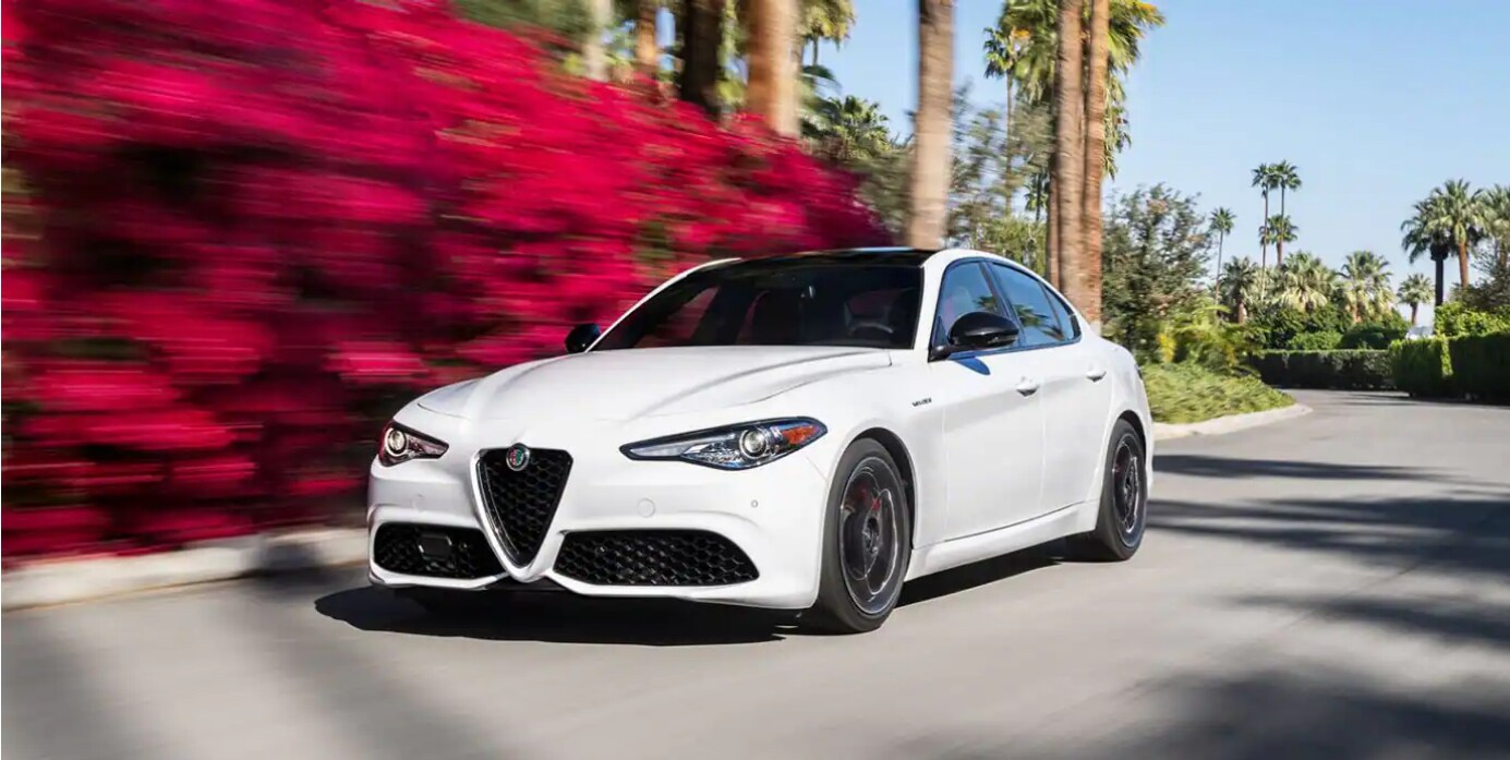 2023 Alfa Romeo Giulia white exterior color driving on the road