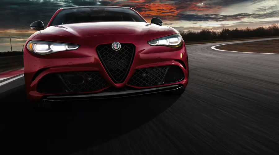 Interior view of 2026 Alfa Romeo Giulia cabin showing black leather seats and sport steering wheel