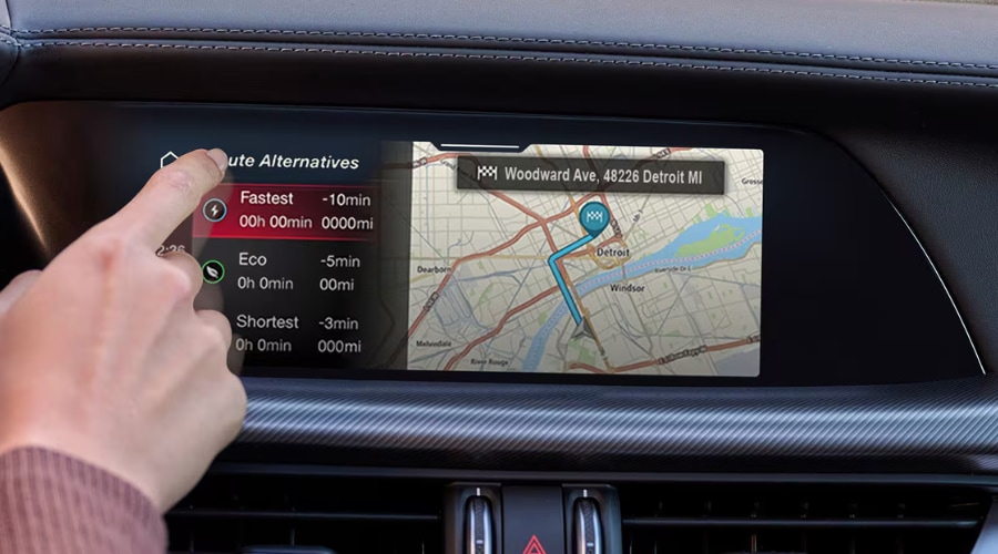 Driver operating the touchscreen infotainment navigation system inside the 2026 Alfa Romeo Stelvio in Ramsey, NJ