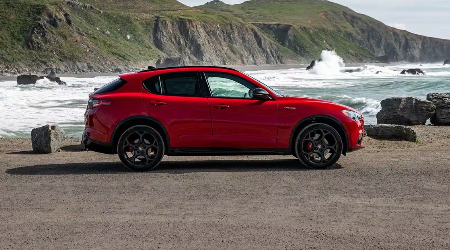 Side profile of a red 2026 Alfa Romeo Stelvio featuring near 50/50 weight distribution and Q4 AWD control near Ramsey, NJ