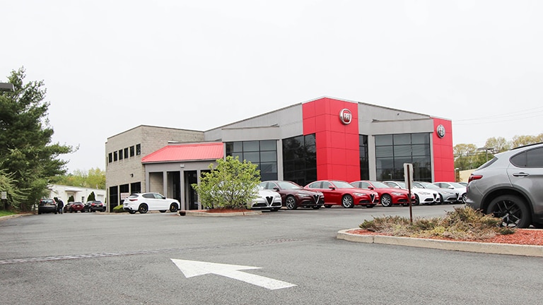 Front showroom display of modern premium vehicles at Ramsey Alfa Romeo in Upper Saddle River New Jersey