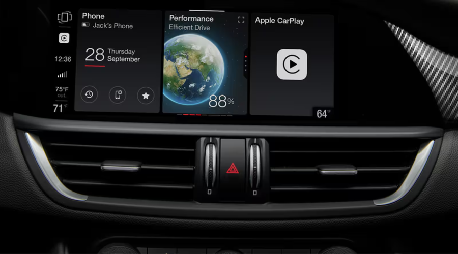 Close-up view of the 8.8-inch multi-touch central display in a 2026 Alfa Romeo Giulia AWD, showcasing customizable widget tiles for Apple CarPlay, phone connectivity, performance metrics, and carbon fiber dash trim, available at Ramsey Alfa Romeo in Ramsey, NJ serving Bergen County drivers.