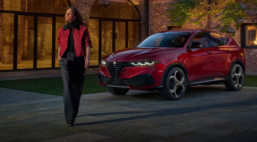 The 2026 Alfa Romeo Tonale PHEV navigating wet winter pavement in Mahwah NJ with standard Q4 All-Wheel Drive traction.