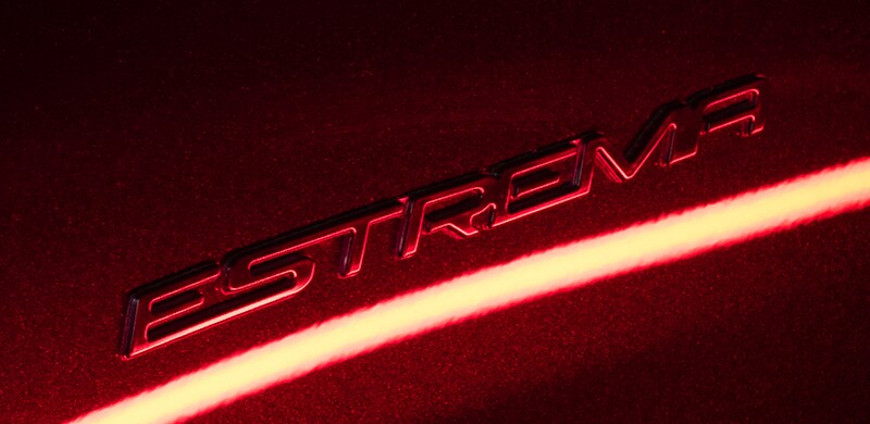 The badging on the fenders and rear has a dark "Estrema" nameplate.