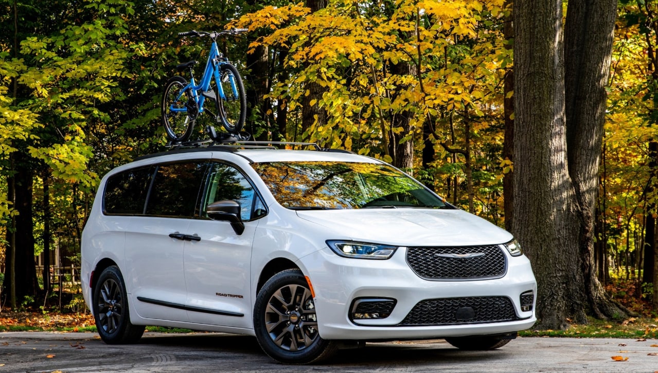 2023 Pacifica AWD parked in front of trees with a bicycle attached to rack
