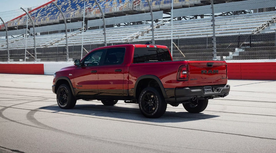 Side dynamic shot of a 2026 Ram 1500 towing a heavy camper trailer near Campgaw Mountain reservation highlighting its high-strength steel frame.