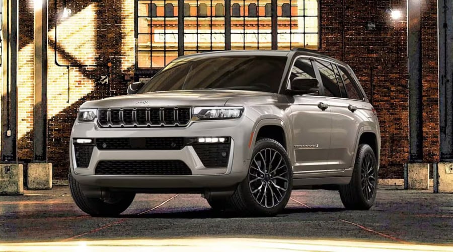 Front three quarter view of a 2026 Jeep Grand Cherokee Summit trim parked near Saddle River County Park highlighting luxury wheels
